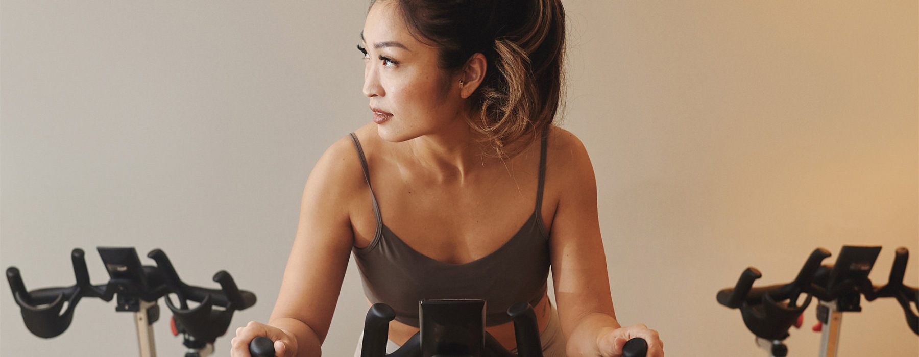 a woman riding a stationary bike