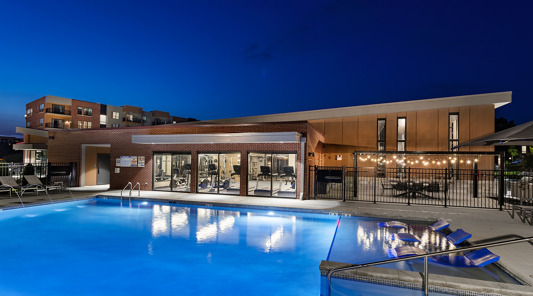 Luxury Apartments East Madison, WI outdoor swimming pool lit at night