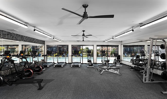 Resort-Style Amenities spacious gym filled with natural light